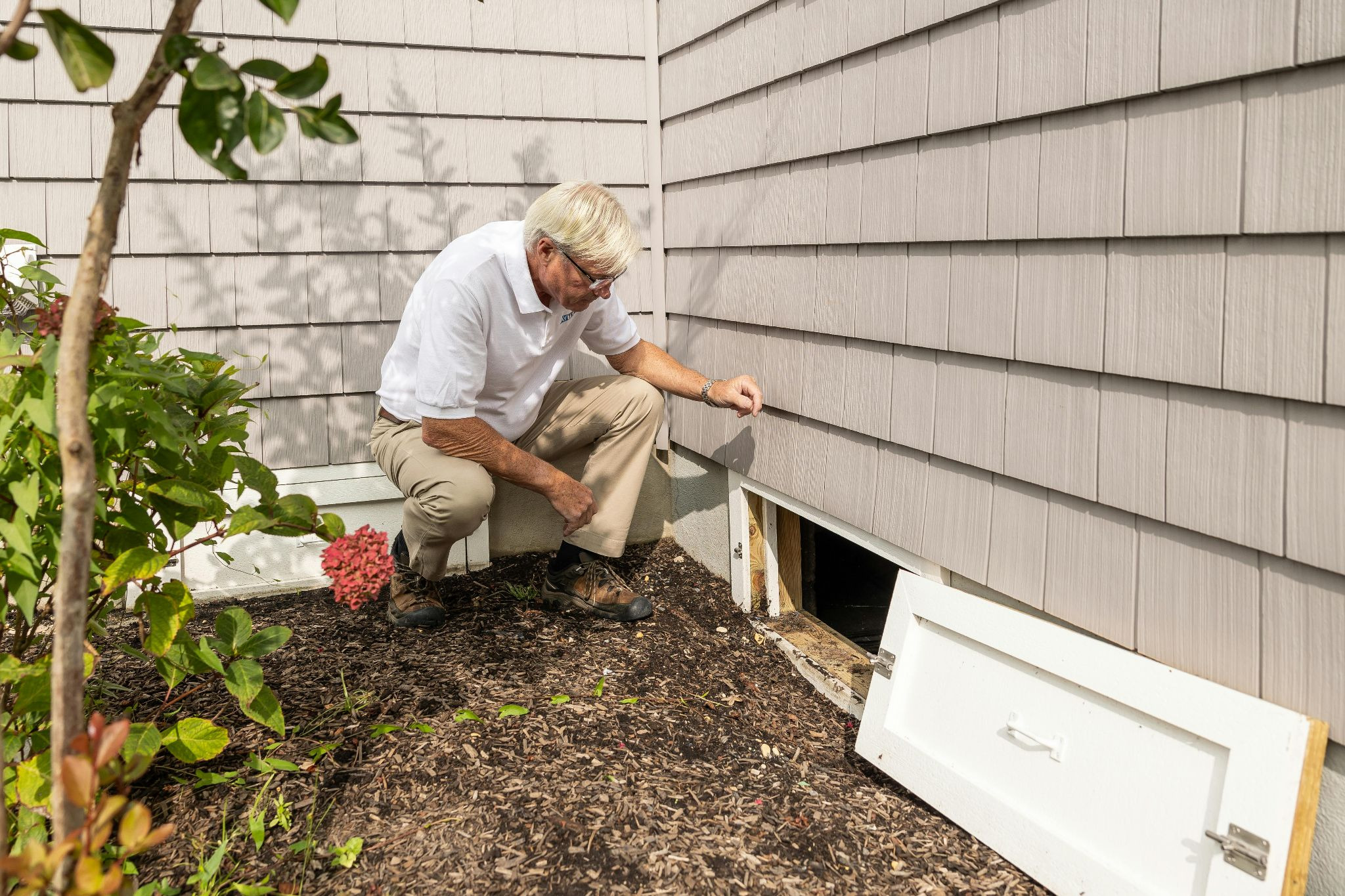 Property Manager inspecting a basement window