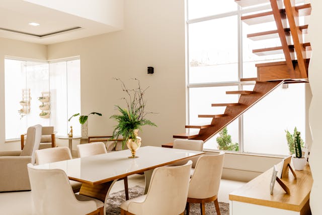 Interior modern beige dining area and open staircase