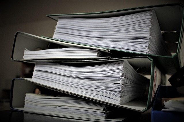 Stacked binders filled with paperwork