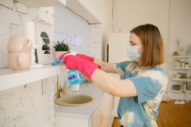 feminine-person-cleaning-home-with-gloves