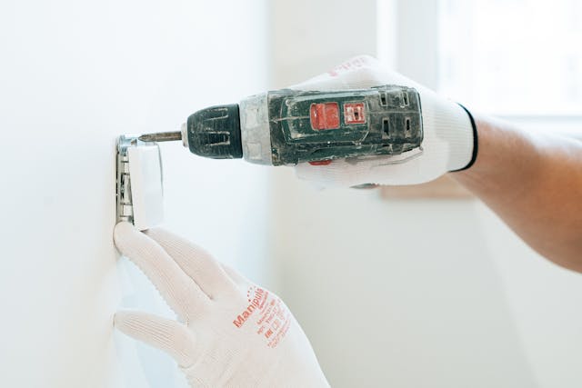 someone drilling into an electrical socket